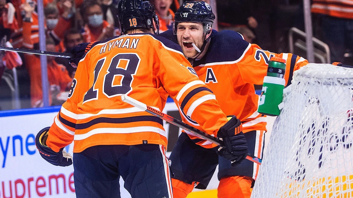 Edmonton Oilers' Zach Hyman (18) and Leon Draisaitl (29) celebrate a goal against the Vancouver Canucks during second period NHL action in Edmonton on Wednesday, October 13, 2021.THE CANADIAN PRESS/Jason Franson
