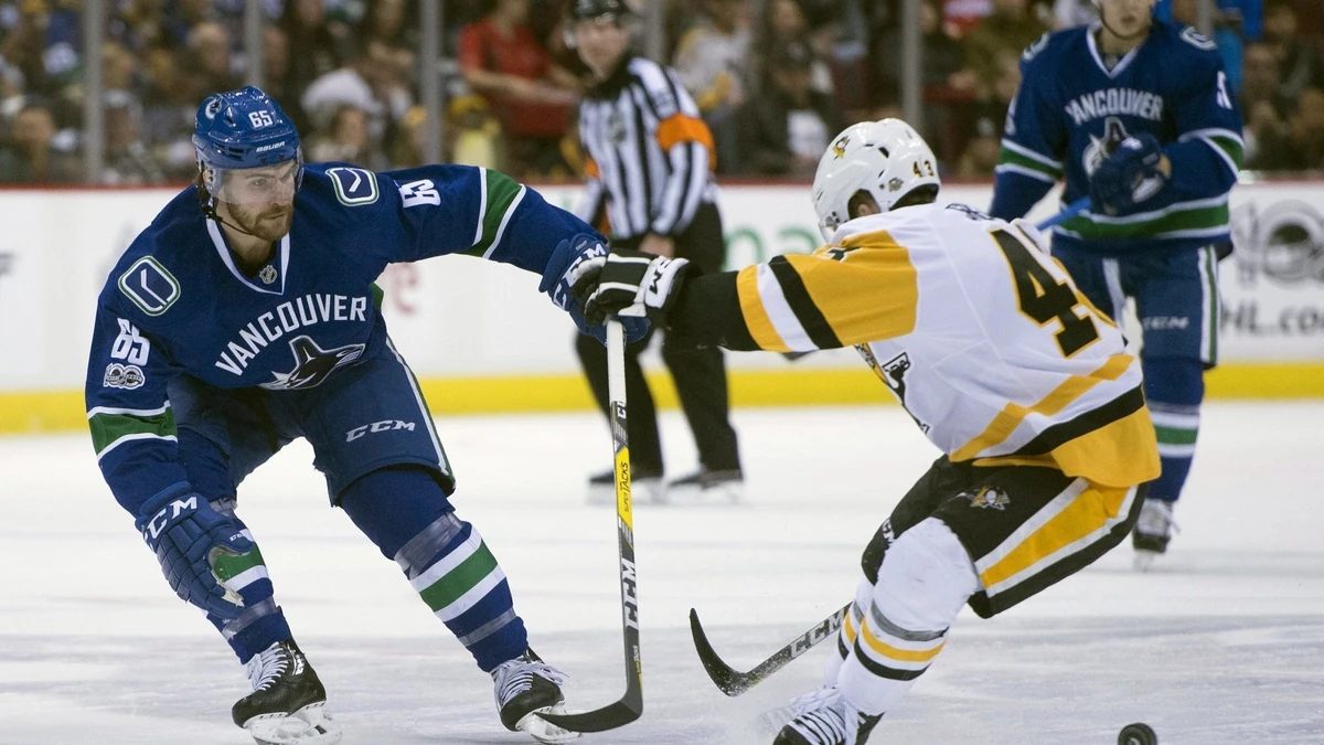 Vancouver Canucks right wing Alexandre Grenier (65) vies for control of the puck with Pittsburgh Penguins left wing Conor Sheary (43) during the first period of an NHL hockey game Saturday, March 11, 2017, in Vancouver, British Columbia. (Jonathan Hayward/The Canadian Press via AP) |
