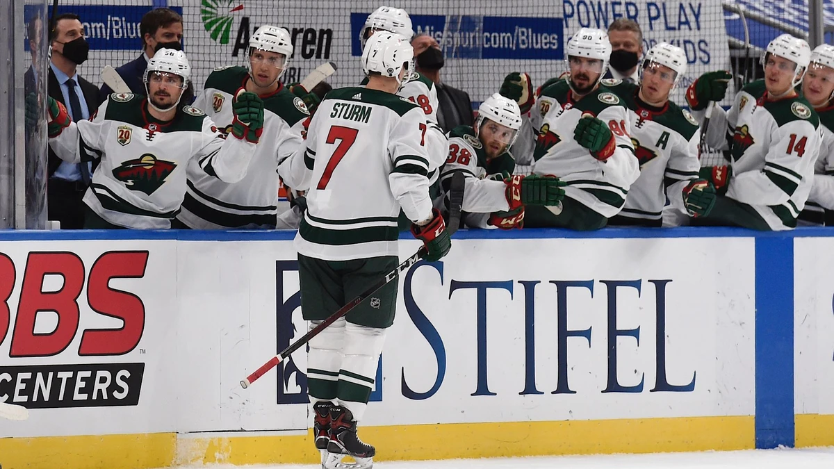 Minnesota Wild's Nico Sturm (7) is congratulated by teammates after scoring a goal against the St. Louis Blues during the first period of an NHL hockey game on Saturday, April 10, 2021, in St. Louis. (AP Photo/Joe Puetz)