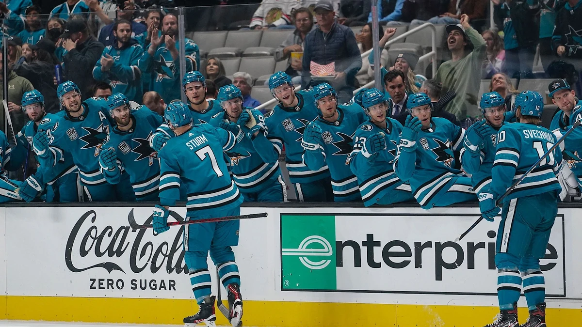 San Jose Sharks center Nico Sturm (7) celebrates with teammates after scoring against the Chicago Blackhawks during the first period of an NHL hockey game in San Jose, Calif., Saturday, Oct. 15, 2022. (AP Photo/Godofredo A. Vásquez)