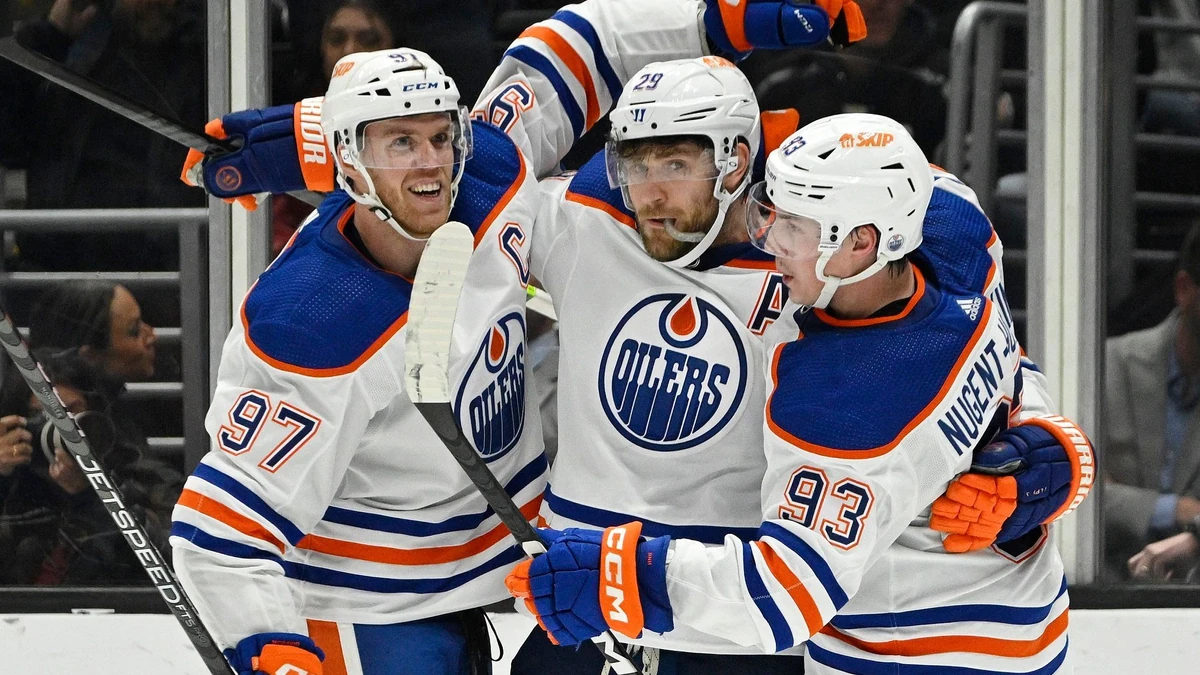 Edmonton Oilers center Leon Draisaitl, center, celebrates his goal with center Connor McDavid, left, and center Ryan Nugent-Hopkins during the second period of an NHL hockey game Tuesday, April 4, 2023, in Los Angeles. (AP Photo/Mark J. Terrill)