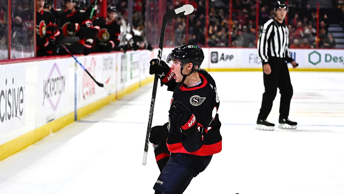 Ottawa Senators left wing Tim Stutzle slides on the ice as he celebrates his goal against the Boston Bruins during the second period of an NHL hockey game in Ottawa, Ontario, on Tuesday, Dec. 27, 2022. (Justin Tang/The Canadian Press via AP)