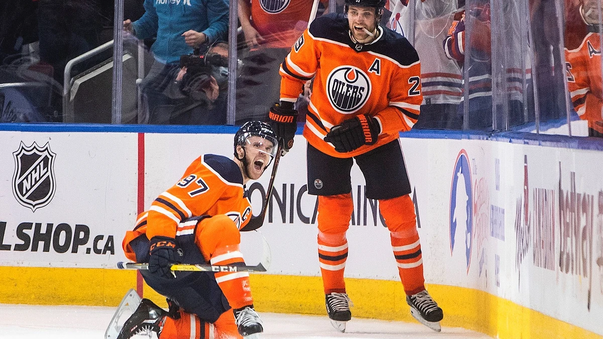 Edmonton Oilers' Connor McDavid (97) and Leon Draisaitl (29) celebrate a goal against the New York Rangers during the third period of an NHL hockey game Friday, Nov. 5, 2021, in Edmonton, Alberta. (Jason Franson/The Canadian Press via AP)