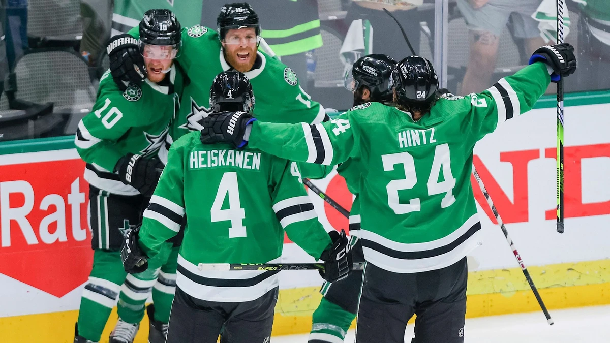 Dallas Stars, including Ty Dellandrea (10), Miro Heiskanen (4) and Roope Hintz (24) celebrate with Joe Pavelski (16) after his overtime goal against the Vegas Golden Knights in Game 4 of the NHL hockey Stanley Cup Western Conference finals Thursday, May 25, 2023, in Dallas. (AP Photo/Gareth Patterson)