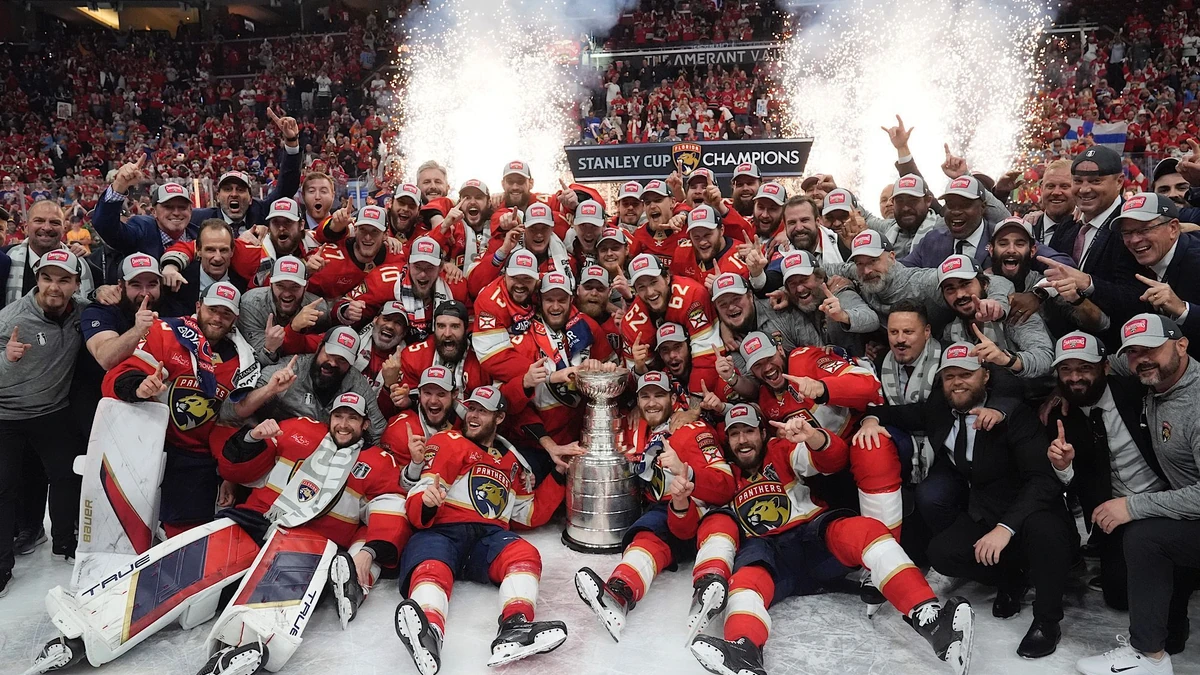 The Florida Panthers team poses with the Stanley Cup trophy after defeating the Edmonton Oilers in Game 7 of the NHL hockey Stanley Cup Final, Monday, June 24, 2024, in Sunrise, Fla. The Panthers defeated the Oilers 2-1. (AP Photo/Wilfredo Lee)