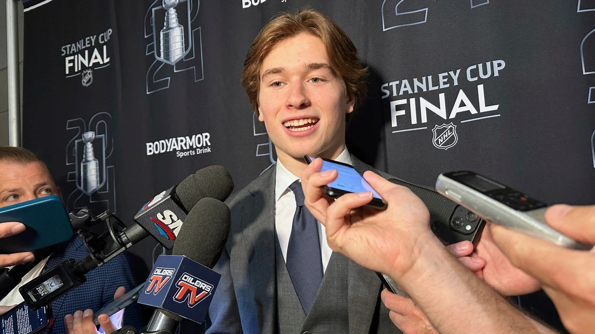 FILE - Macklin Celebrini, the expected No. 1 pick in the NHL draft to the San Jose Sharks, speaks with reporters prior to Game 2 of the Stanley Cup Final at Amerant Bank Arena in Sunrise, Florida, Monday, June 10, 2024. Celebrini sets aside his NBA ties by looking ahead to a hockey career, entering the NHL draft as the presumptive No. 1 pick on Friday, June 28. (AP Photo/Stephen Whyno, File)