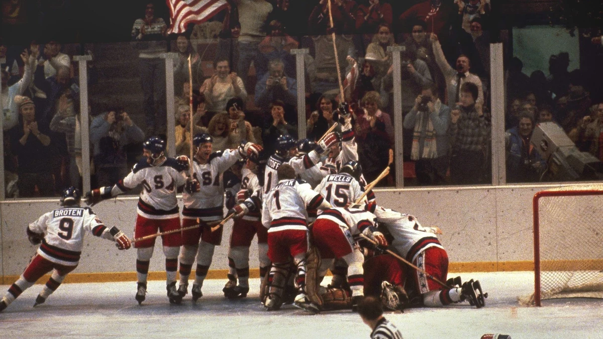 FILE - In this Feb. 22, 1980, file photo, the U.S. hockey team pounces on goalie Jim Craig after a 4-3 victory against the Soviets in the 1980 Olympics, as a flag waves from the Lake Placid, N.Y. crowd. The Lake Placid Games were staged at a time of upheaval in the world. The Soviet Union had invaded Afghanistan, militants in Iran had seized the U.S. embassy in Tehran, and the United States boycotted the Summer Olympics in Moscow later in the year because of the situation in Afghanistan. The effect of what transpired here is not lost on those who experienced it. The 40th anniversary celebration begins Friday evening, Feb. 14, 2020, with a torch run (AP Photo, File) |