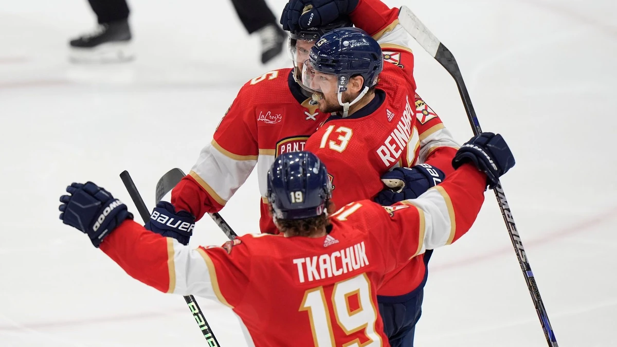 Florida Panthers center Sam Reinhart (13) is congratulated by center Aleksander Barkov, rear, and left wing Matthew Tkachuk (19) after Reinhart scored during an overtime period of Game 4 during the Eastern Conference finals of the NHL hockey Stanley Cup playoffs to beat the New York Rangers, Tuesday, May 28, 2024, in Sunrise, Fla. (AP Photo/Wilfredo Lee)